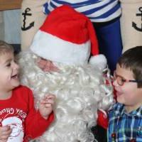 Santa laughing with two kids